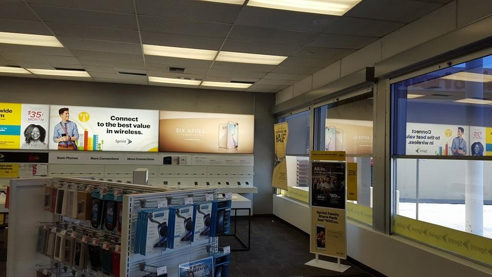 Interior of Sprint mobile phone retail store with display cases and signage promoting wireless services